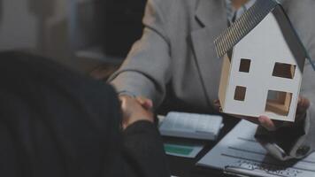 A person shaking hands with a house model video