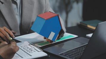 A real estate agent is working on a contract with a client video