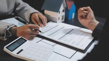 A real estate agent and a client signing a contract video