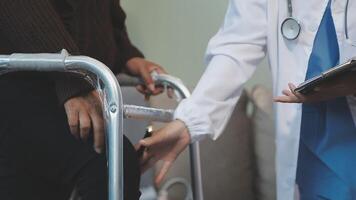 A doctor is helping a patient with a walker video