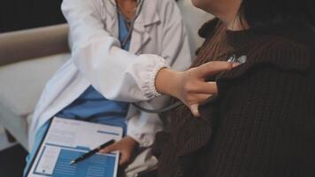 A doctor is checking the heart rate of a woman video
