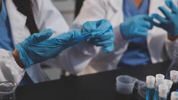 Two women in lab coats and blue gloves video