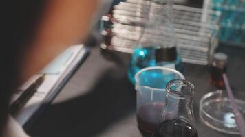 A person is working in a laboratory with a beaker video