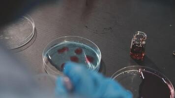 A person in a lab coat is holding a test tube video