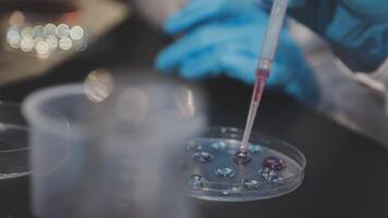 A person in a lab coat is holding a test tube video