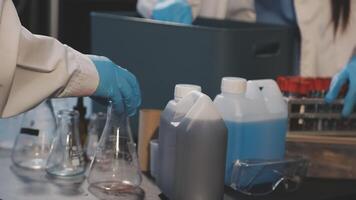 A person in a lab coat is holding a container video