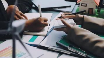 Business people working on a calculator and writing on paper video