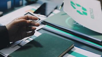A man's hand holding a paper with a recycling symbol video