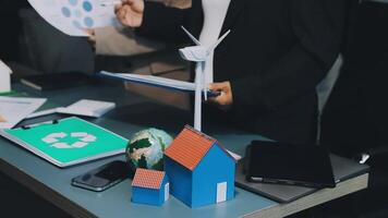 A man is holding a paper with a wind turbine on it video