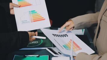 Two people holding papers with graphs on them video