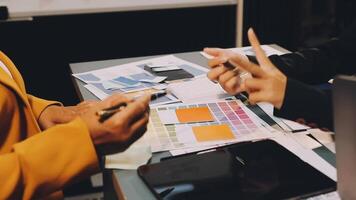 Two people working on a project at a desk video