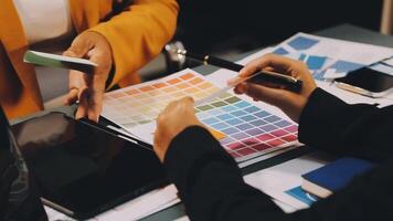 A business person is using a color swatch to choose a color video