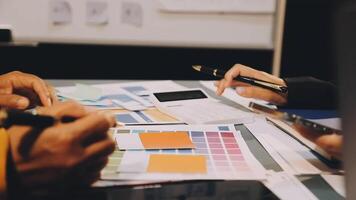 People working on a design project at a table video
