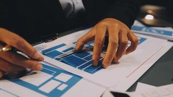A person is working on blueprints with a pen video