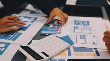 Business people working on a project with a calculator and paper video