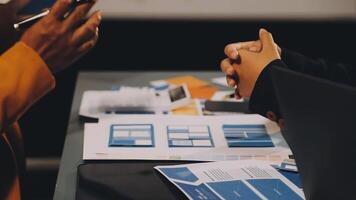 Two people shaking hands at a table with papers and papers video