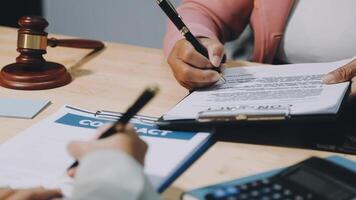 A lawyer signing a contract with a client video