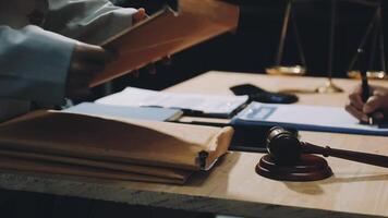 A judge is holding a gavel and a paper with a pen video