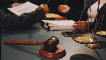Lawyer and judge sitting at a desk with a gavel and a scale of justice video