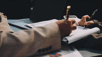 Two people are working on a document with a pen and paper video