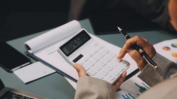 A person is using a calculator to calculate the numbers video