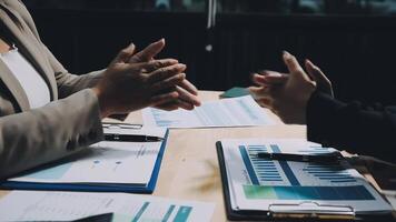 Two business people shaking hands at a table video