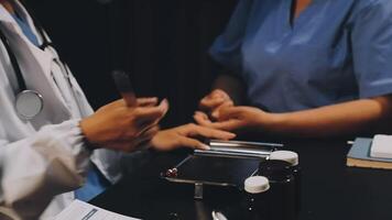 A doctor and a nurse are working on a computer video