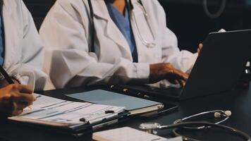 Two doctors working on a laptop video