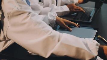 A group of doctors working on laptops video