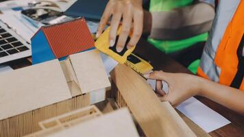 A person is working on a model of a house video