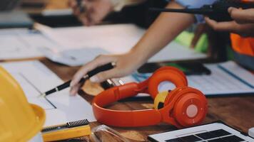A person wearing a hard hat and headphones working on a project video