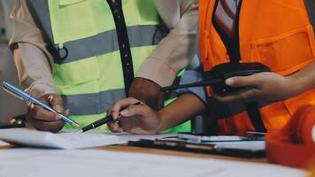 Two construction workers are working on a project video