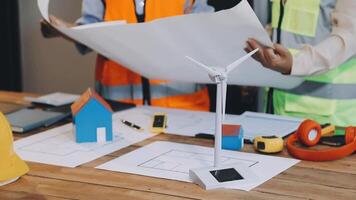 Two people working on a construction project with a wind turbine video