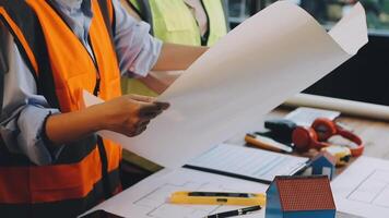 Two people working on construction plans video