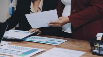 Two business people are working on paperwork at a desk video