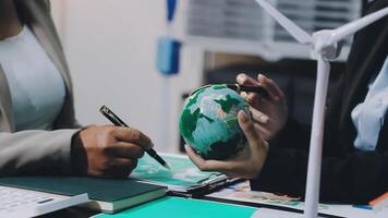 Business people working together on a project with a globe video
