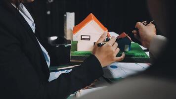 A person is holding a model of a house video