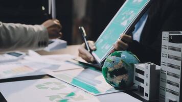 Business people working on a project with a globe and paper video