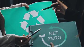 Two people holding up a net zero sign video