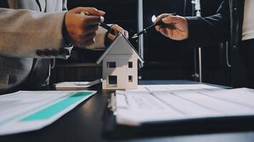 Two people holding a house model on a table video