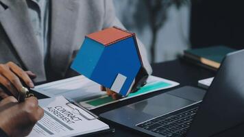A real estate agent is working on a contract with a client video