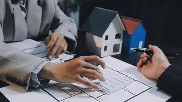 Two people are working on a house model video