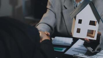 A person shaking hands with a house model video