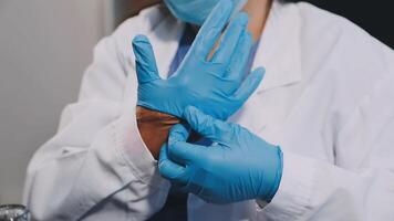 A woman in a lab coat and blue gloves video