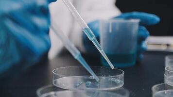 A person in a lab coat holding a test tube video