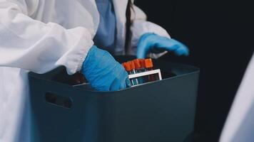 A person in a lab coat is holding a container with a plastic bag video