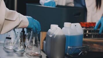 A person in a lab coat is holding a container video