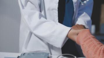 A doctor shaking hands with a patient video