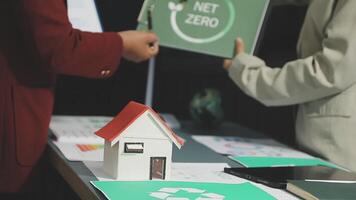 Business people holding a net zero sign and a house with a recycling symbol video