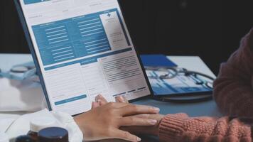 A doctor's hand holding a clipboard with a patient's medical records video